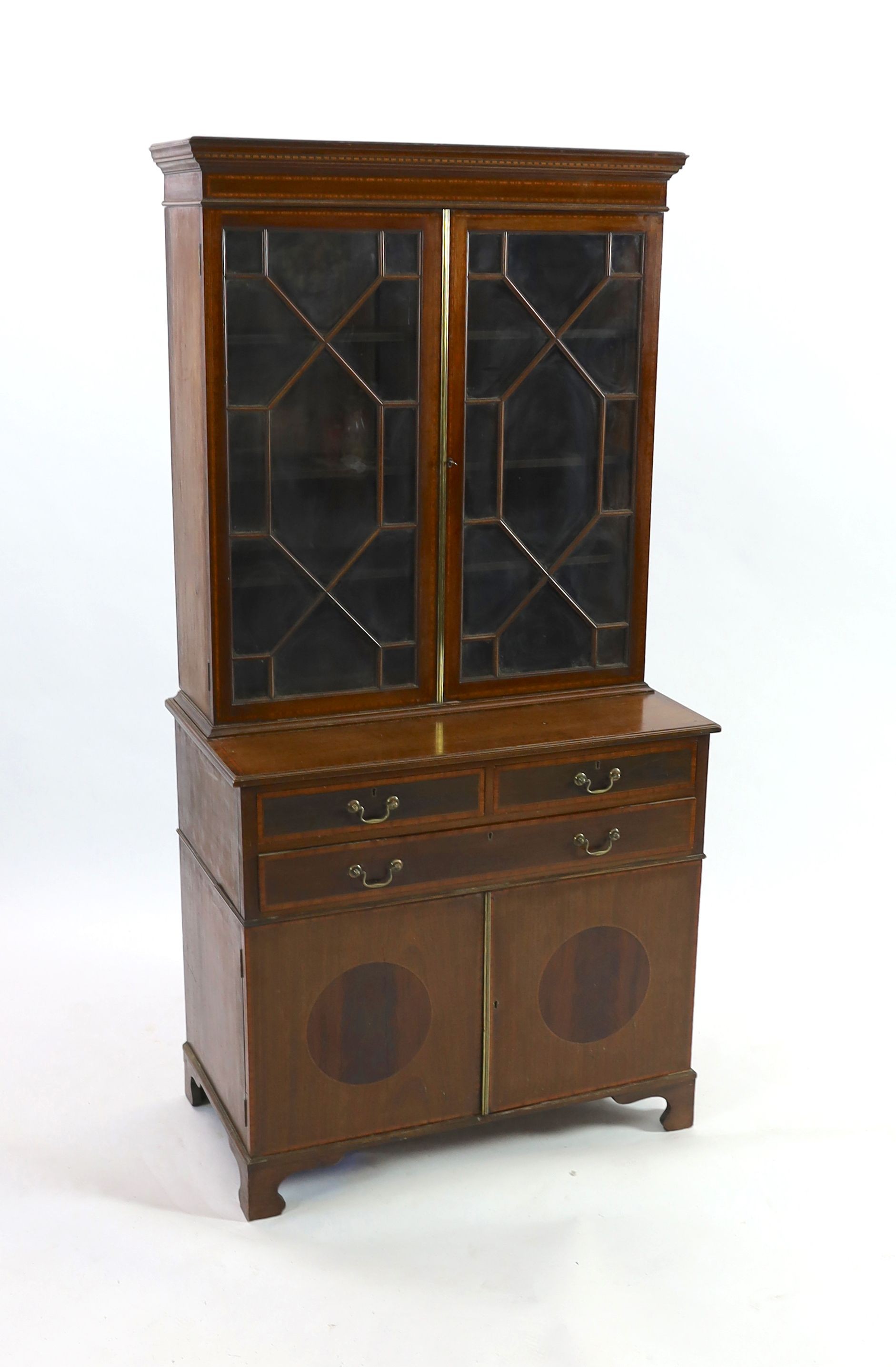 An Edwardian satinwood banded mahogany bookcase cupboard, fitted three drawers, width 91cm depth 50cm height 182cm